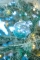 Mise en situation dans le sapin des boules en verre de Noël pour sapin transparentes avec paillettes bleues
