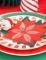 Mise en situation sur une table des serviettes en papier fleur de Noël poinsettia